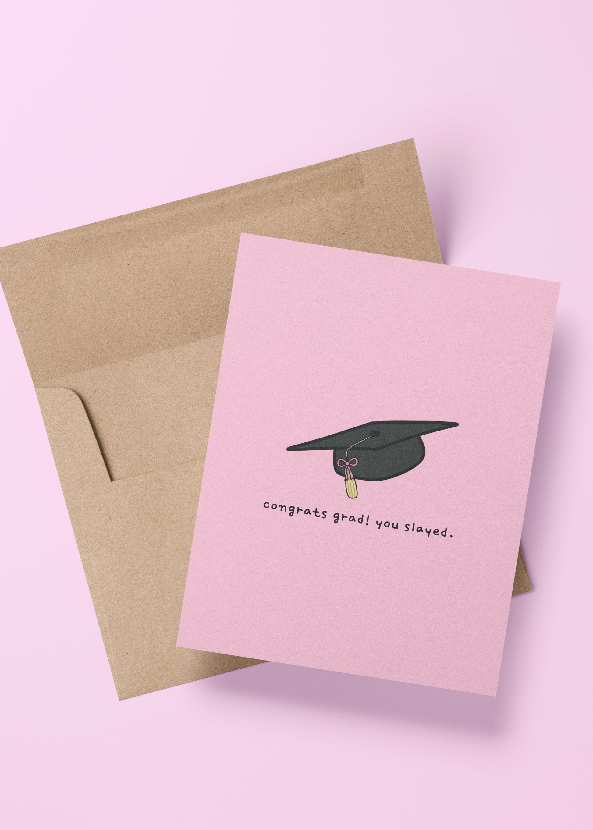 graduation card with “congrats grad! you slayed!” message and illustrations of a pink bow and grad cap – cute and sassy card for graduates